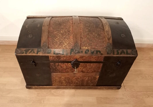 Restored antique curved wooden trunk from the 19th century with metal bands and double lock