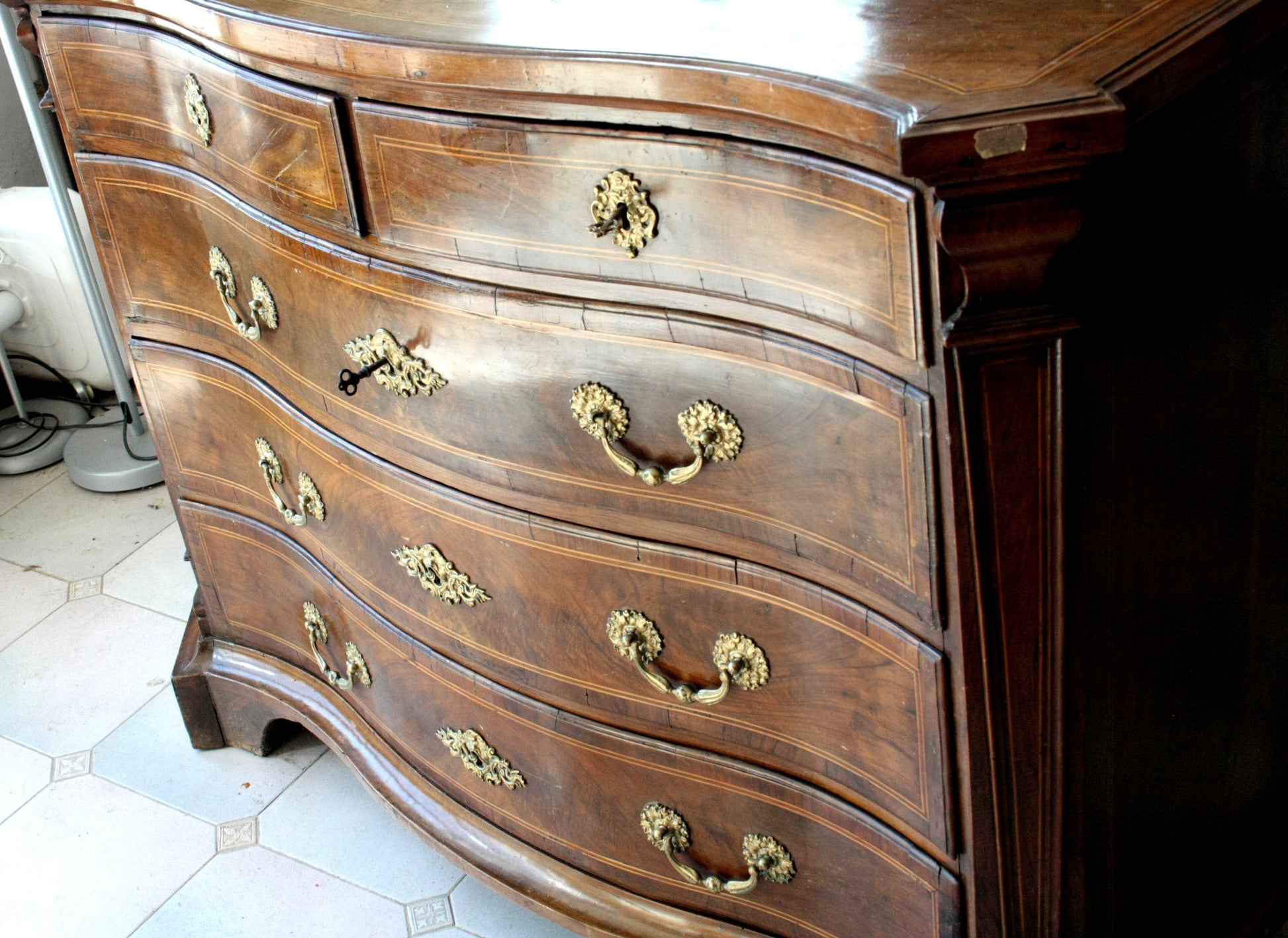 Antique bombe chest of drawers with ornate brass hardware for vintage casa design