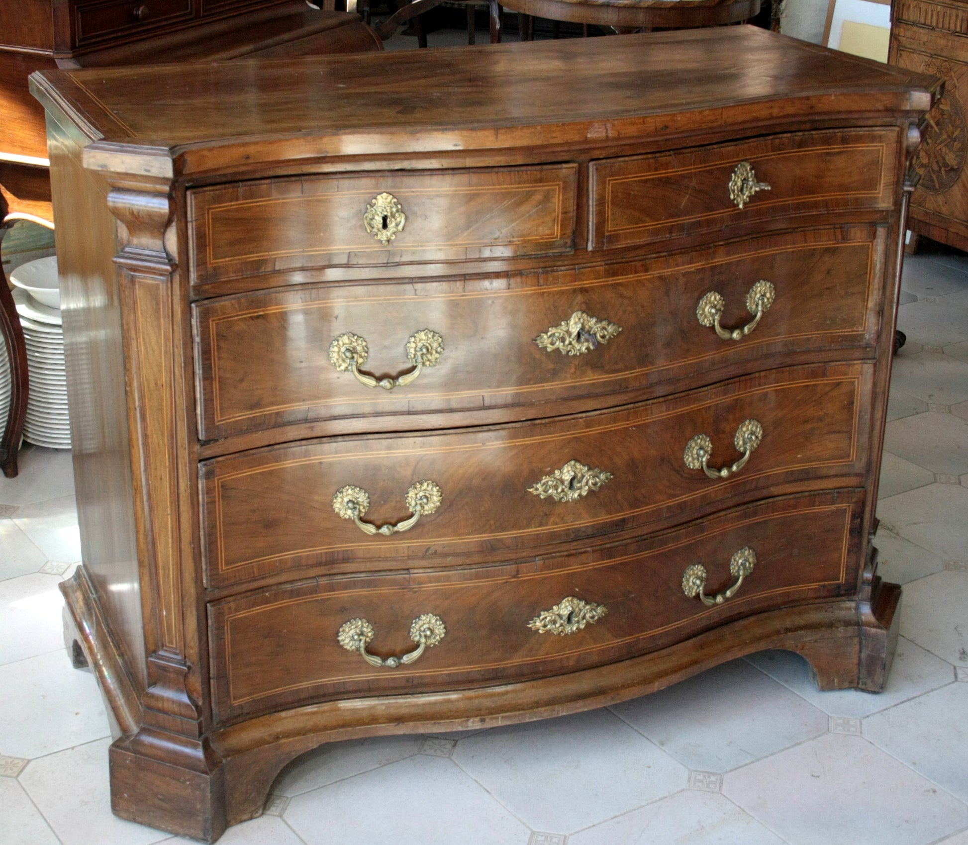 Alt testo di un cassettone bombe vintage in legno con hardware in ottone, perfetto per casa design
