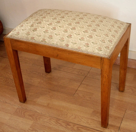 Vintage 20th century stool-bench in solid walnut with padded covering, a refined example dating back to the 1950s-60s