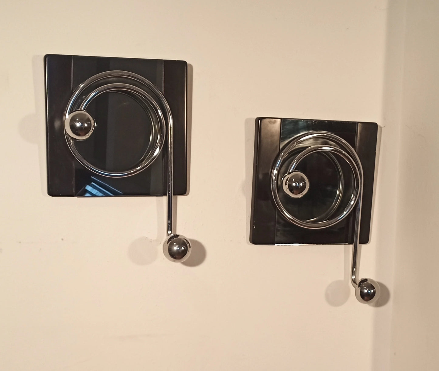 Due eleganti ganci appendiabiti da parete di willy rizzo con design a spirale in cromo su piastre nere anni 70