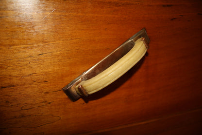 Vintage drawer pull in noce wood on a mid century modern art deco secretaire from 1950s italy